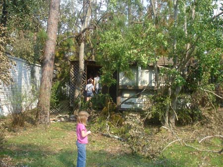 Food Recipient in Sidell LA Trailer Park - Old Woman with tree in dining room