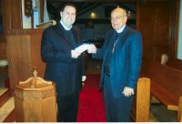 Rev. Walt Otten presenting donation check to Rev. Benjamin Ball of St. Paul - Brookfield